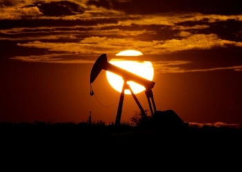 The sun sets behind an idle pump jack near Karnes City, Texas, Wednesday, April 8, 2020. Demand for oil continues to fall due to the new coronavirus outbreak. (AP Photo/Eric Gay)