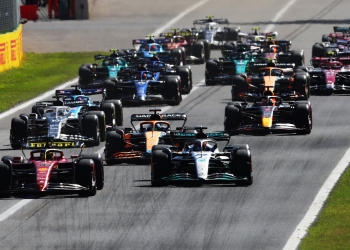 MONZA, ITALY - SEPTEMBER 11: Charles Leclerc of Monaco driving the (16) Ferrari F1-75 leads George Russell of Great Britain driving the (63) Mercedes AMG Petronas F1 Team W13 and the rest of the field into turn one at the start during the F1 Grand Prix of Italy at Autodromo Nazionale Monza on September 11, 2022 in Monza, Italy. (Photo by Joe Portlock - Formula 1/Formula 1 via Getty Images)