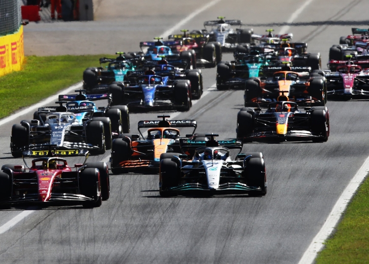 MONZA, ITALY - SEPTEMBER 11: Charles Leclerc of Monaco driving the (16) Ferrari F1-75 leads George Russell of Great Britain driving the (63) Mercedes AMG Petronas F1 Team W13 and the rest of the field into turn one at the start during the F1 Grand Prix of Italy at Autodromo Nazionale Monza on September 11, 2022 in Monza, Italy. (Photo by Joe Portlock - Formula 1/Formula 1 via Getty Images)
