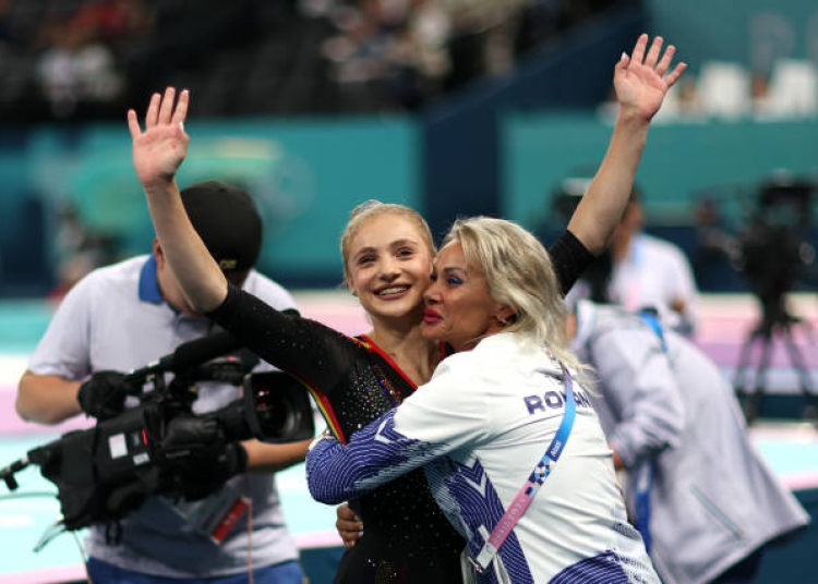 PARIS, FRANCE - JULY 28: Sabrina Maneca-Voinea of Team Romania reacts with her coach Camelia Voinea after finishing her routine on the balance beam during the Artistic Gymnastics Women's Qualification on day two of the Olympic Games Paris 2024 at Bercy Arena on July 28, 2024 in Paris, France. (Photo by Naomi Baker/Getty Images)